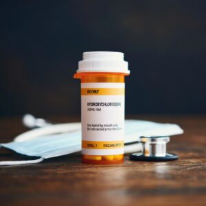 Stethoscope and Face Mask with Prescription Medication in Pill Bottle: Hydroxychloroquine Phosphate