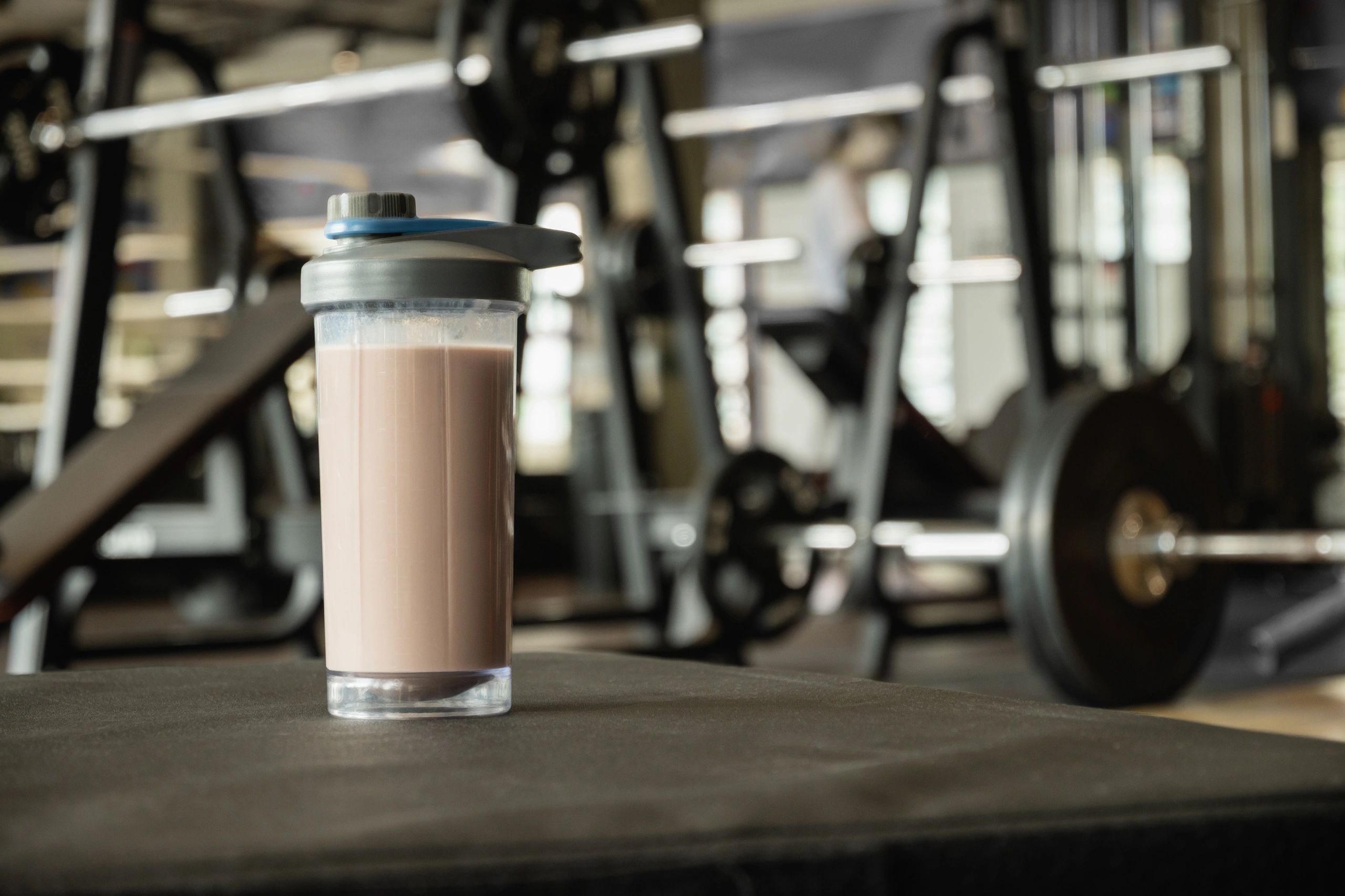 Protein shake bottle on a gym bench