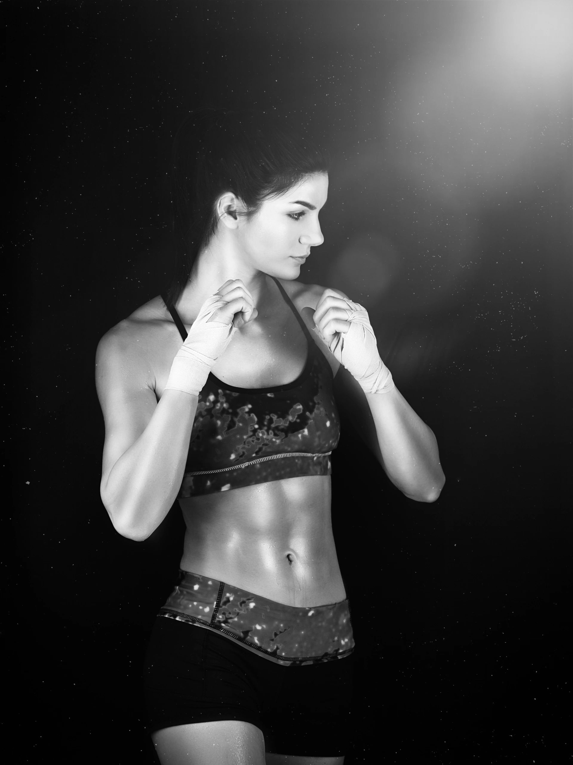 Muscular woman training in a studio